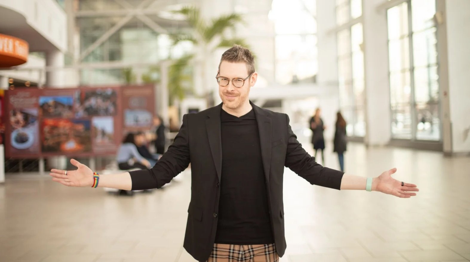 JAD with arms outstretched in a welcoming posture